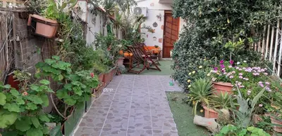 a garden path with plants and flowers and a table at La Palma San Francesco in Sferracavallo
