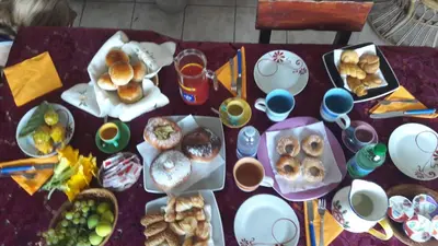 a table topped with plates of food and cups of coffee at La Palma San Francesco in Sferracavallo