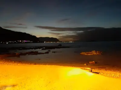 a view of the beach at night at La Palma San Francesco in Sferracavallo