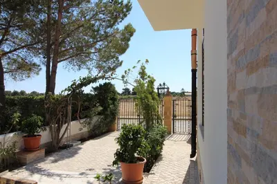 a balcony with potted plants and a fence at B&B Villa Bea in San Vito lo Capo