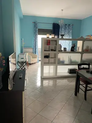 a living room with a white shelving unit at Esmeralda Apartment in Palermo