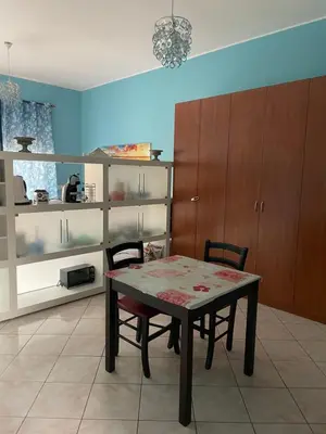 a dining room with a table and two chairs at Esmeralda Apartment in Palermo