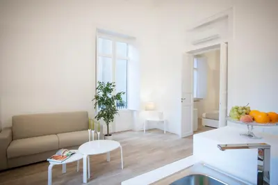 a living room with a couch and a table at Politeama Apartments by Giorgio in Palermo