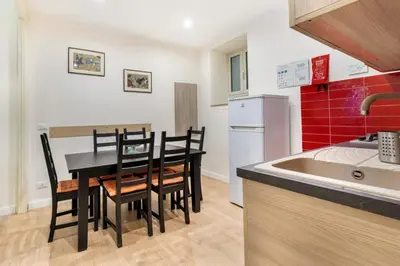 a kitchen with a table and chairs in a kitchen at Casa Nonna Toto in Palermo