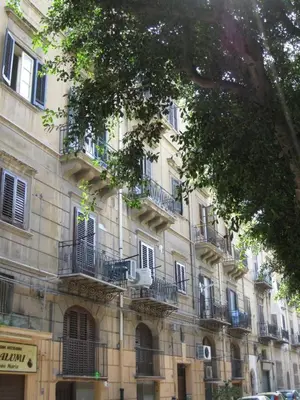 a building with balconies on the side of it at Casa Nonna Toto in Palermo