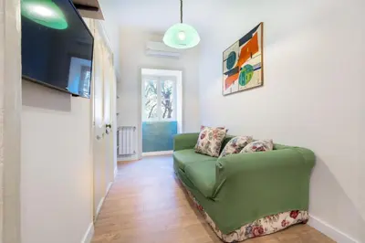 a living room with a green couch in a room at Casa Nonna Toto in Palermo