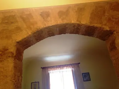 an archway in a room with a window at La Casa Di Tufo in Palermo