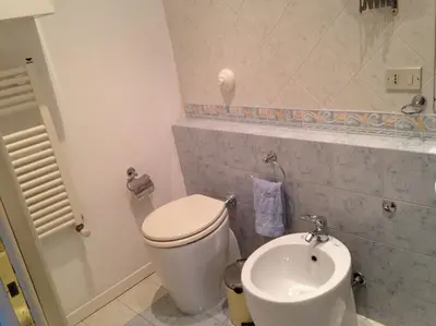 a bathroom with a toilet and a sink at La Casa Di Tufo in Palermo