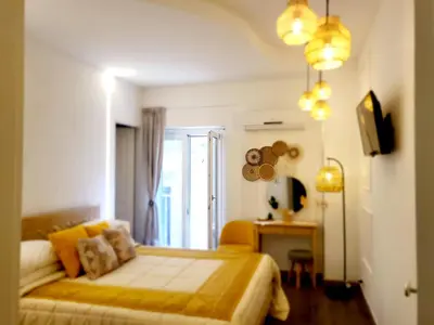 a bedroom with a bed with a yellow blanket at Atrium in Castellammare del Golfo