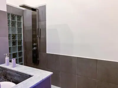 a bathroom with a sink and a mirror at Liberty Suites in Palermo