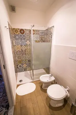a bathroom with two toilets and a shower at Liberty Suites in Palermo