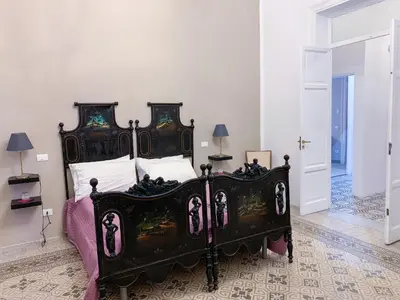 a bedroom with a large black bed in a room at Liberty Suites in Palermo