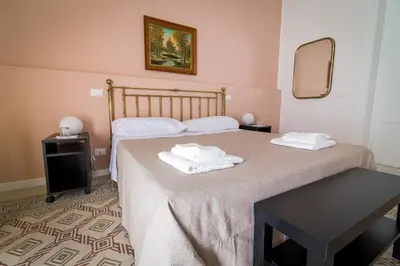 a bedroom with two beds with towels on them at Liberty Suites in Palermo