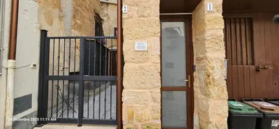 an entrance to a building with a gate and a door at Nelle Antiche Mura in Castellammare del Golfo