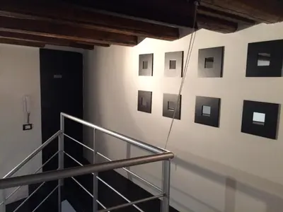 a staircase with pictures on the wall of a building at Corsovittorio111 in Palermo