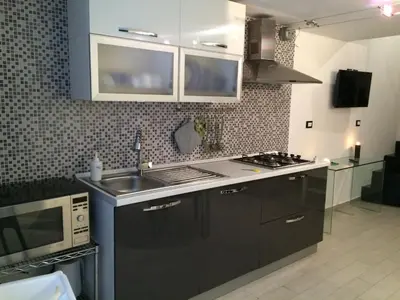 a kitchen with a sink and a stove at Corsovittorio111 in Palermo