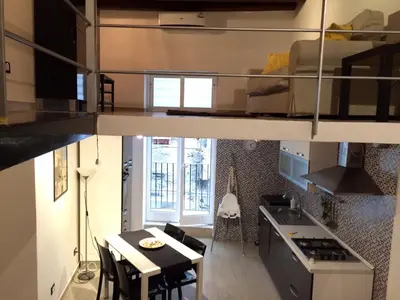 a small apartment with a dining room and a kitchen at Corsovittorio111 in Palermo