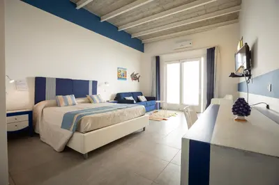 a bedroom with a large bed and a blue ceiling at B&B Kolors in Castellammare del Golfo
