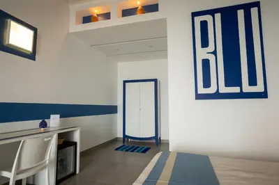 a room with a blue and white wall with a mirror at B&B Kolors in Castellammare del Golfo