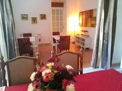 a living room with a table with flowers on it at Palermo Centrale in Palermo