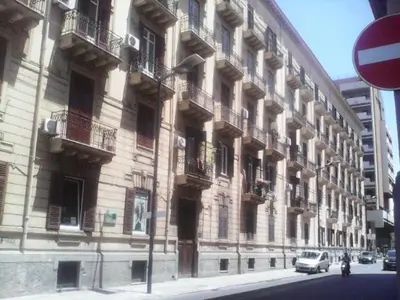 a large building on the side of a street at Palermo Centrale in Palermo