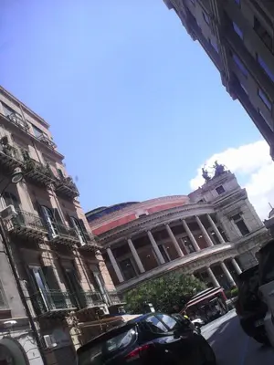a large building with cars parked in front of it at Palermo Centrale in Palermo