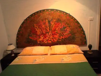 a bed with a large painting on the wall at Palermo Centrale in Palermo
