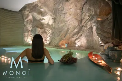 a woman sitting in a hot tub with a bowl of fruit at Marina Holiday Hotel & Spa in Balestrate
