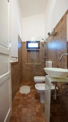 a bathroom with a sink and a toilet at Residence Guidaloca in Scopello