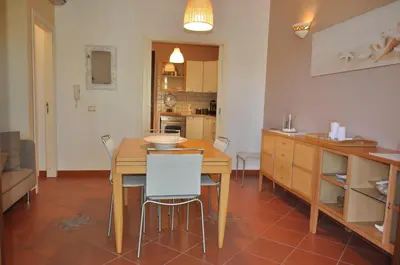 a kitchen and dining room with a table and chairs at casa Francy in San Vito lo Capo