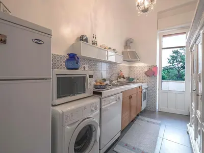 a kitchen with a washer and a sink and a dishwasher at Casa Rosa in Palermo