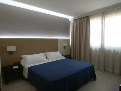 a hotel room with a bed and a window at San Paolo Palace Hotel in Palermo