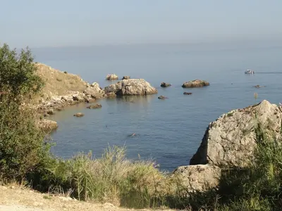 a large body of water with rocks in it at Piccola Baia in Scopello
