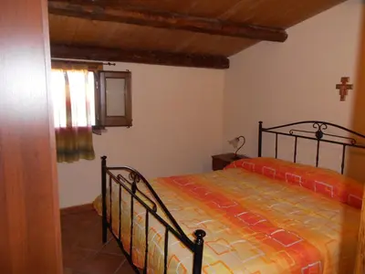 a bedroom with a bed in the corner of a room at Villa delle Cecilie in Partinico