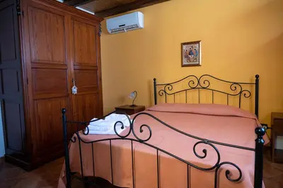 a bedroom with a bed with a pink blanket at Villa delle Cecilie in Partinico
