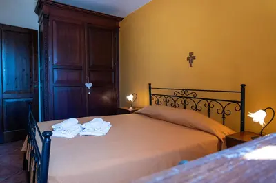 a bedroom with a bed with towels on it at Villa delle Cecilie in Partinico