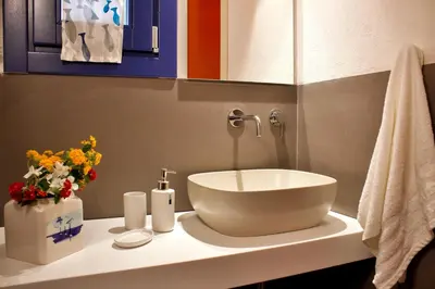 a bathroom with a sink and flowers on a counter at Villa Tramonto in Macari