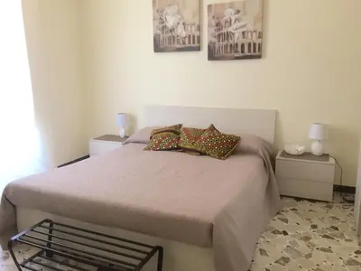 a bedroom with a bed with pillows and two tables at La Cubba in Palermo