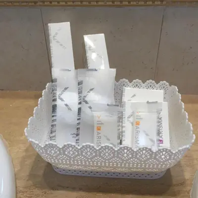a basket filled with white packets on a table at La Cubba in Palermo