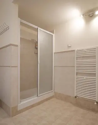 a bathroom with a shower and a walk in closet at La Cubba in Palermo