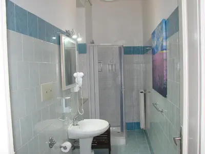 a bathroom with a sink and a shower at La Cubba in Palermo