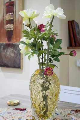a vase with flowers in it on a table at Casa Petra ai Quattro Canti in Palermo