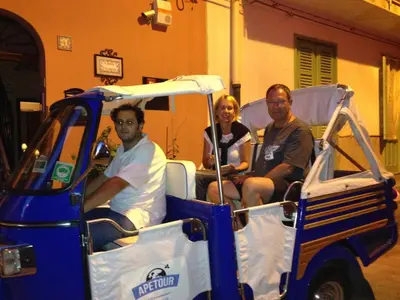 a group of people sitting in a golf cart at B&B Cinisi Vacanze in Cinisi