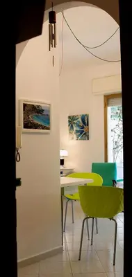 a dining room with a table and chairs at Siciliaiu in Mondello