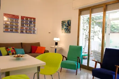 a living room with colorful chairs and a couch at Siciliaiu in Mondello