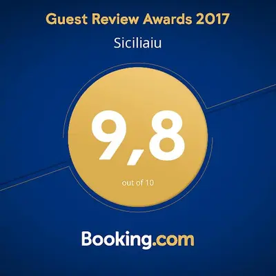 a yellow circle with the text guest review awards at Siciliaiu in Mondello