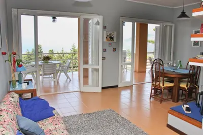 a living room with a couch and a table at Lomarchi Holiday Home in Carini