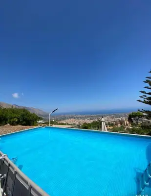 a swimming pool with a view of the ocean at Lomarchi Holiday Home in Carini