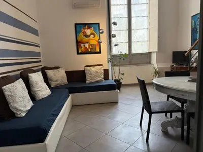 a living room with a couch and a table at Casa Ranieri Palermo in Palermo