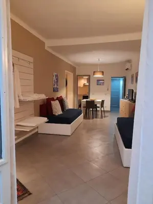 a living room with a couch and a dining room at Casa Ranieri Palermo in Palermo